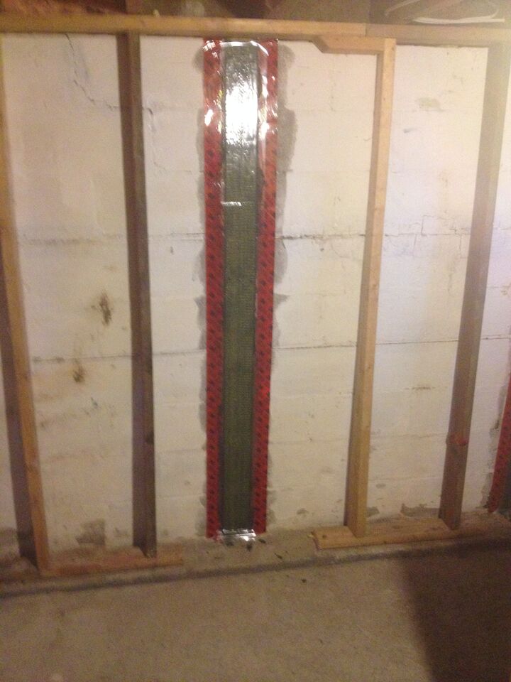 carbon fibre Kevlar sheet straps on a basement wall